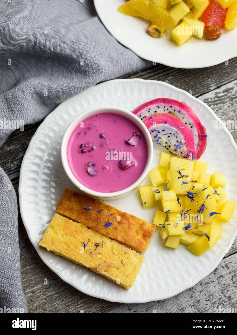 Mango bread with plant-based yogurt and fresh fruits, bright colors, colourful meal, flat lay Stock Photo