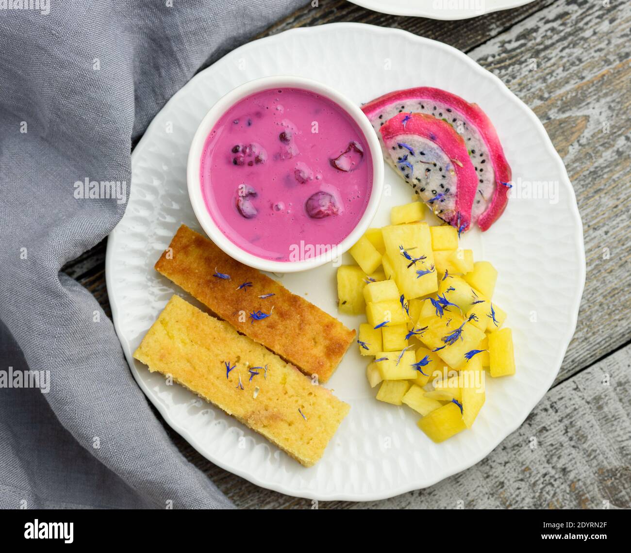 Mango bread with plant-based yogurt and fresh fruits, bright colors, colourful meal, flat lay Stock Photo