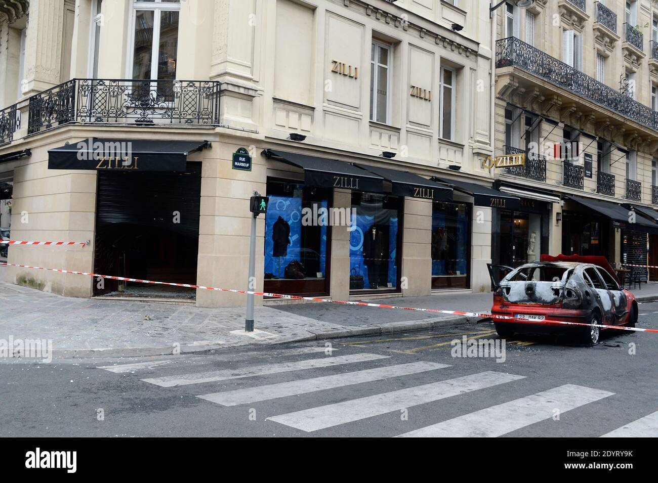 A burnt-out car stands in front of luxury clothing store Zilli in Paris,  France on August 26, 2013. Thieves set the car on fire after they used it  in the early morning
