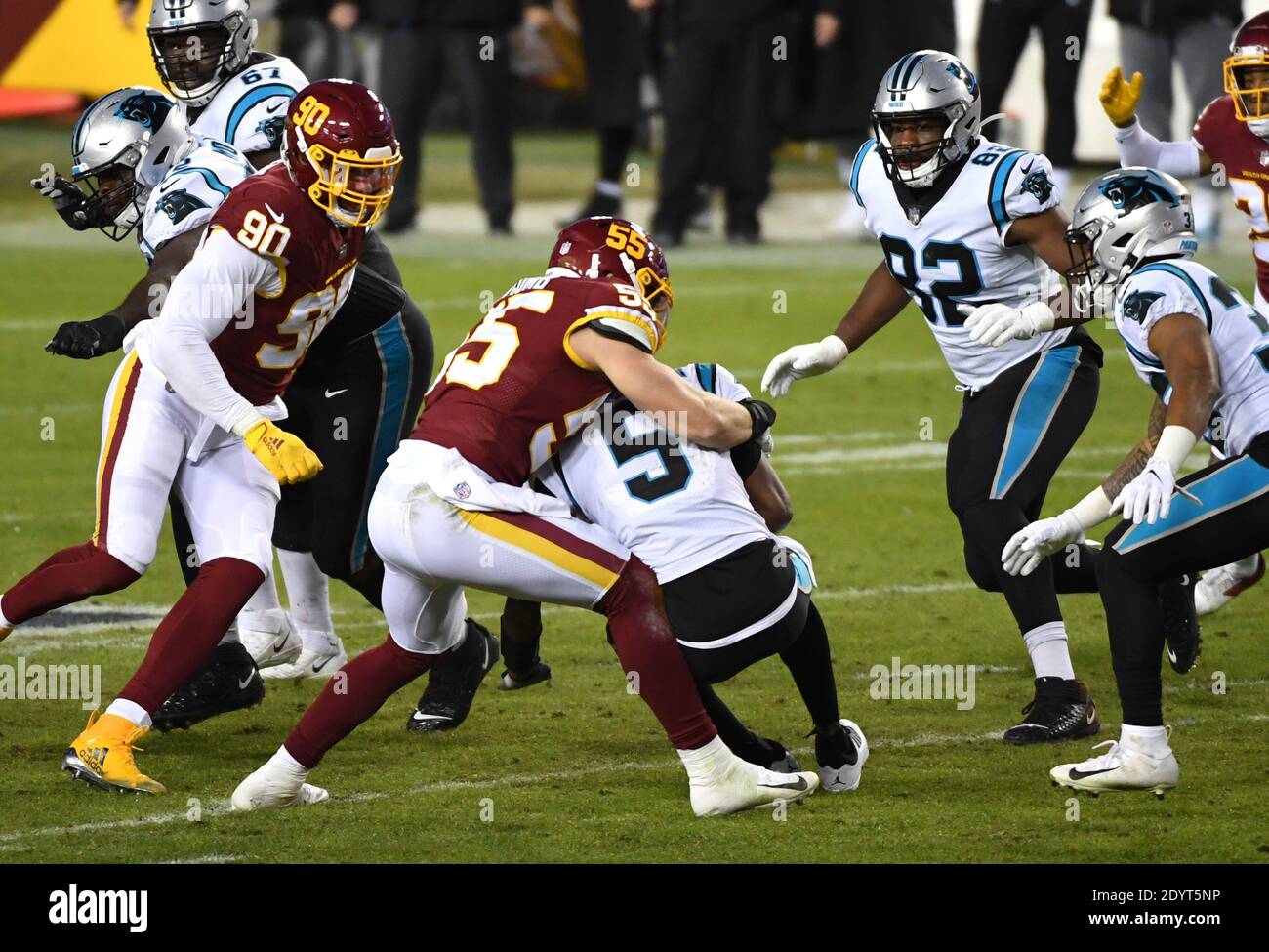 Landover, United States. 25th Oct, 2020. Dallas Cowboys quarterback Andy  Dalton (14) evades Washington Football Team linebacker Cole Holcomb (55)  during the first half of an NFL football game at FedEx Field