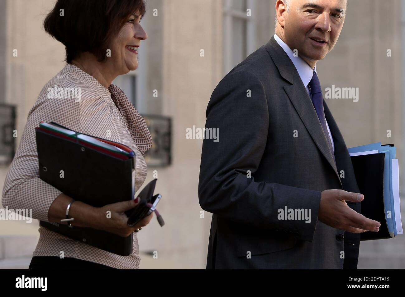 French Junior Minister for Disabled People Marie-Arlette Carlotti and French Finance Minister Pierre Moscovici leave the Elysee presidential Palace after the weekly cabinet meeting, in Paris, France, on september 04 2013. Photo by Stephane Lemouton/ABACAPRESS.COM Stock Photo