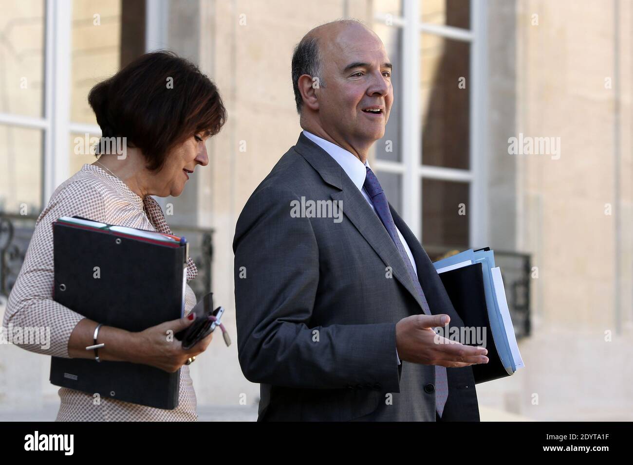 French Junior Minister for Disabled People Marie-Arlette Carlotti and French Finance Minister Pierre Moscovici leave the Elysee presidential Palace after the weekly cabinet meeting, in Paris, France, on september 04 2013. Photo by Stephane Lemouton/ABACAPRESS.COM Stock Photo