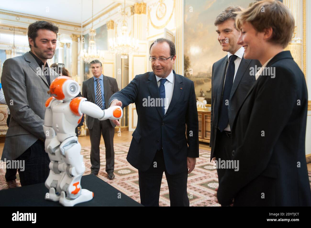 France's President Francois Hollande holds an humanoid robot 'Nao' from Aldebaran Robotics company as he visits an exhibition on French industrial design and technology at the Elysee Palace in Paris, France on September 12, 2013. At R, French Minister for Industrial Recovery Arnaud Montebourg. Photo by Thierry Orban/ABACAPRESS.COM Stock Photo