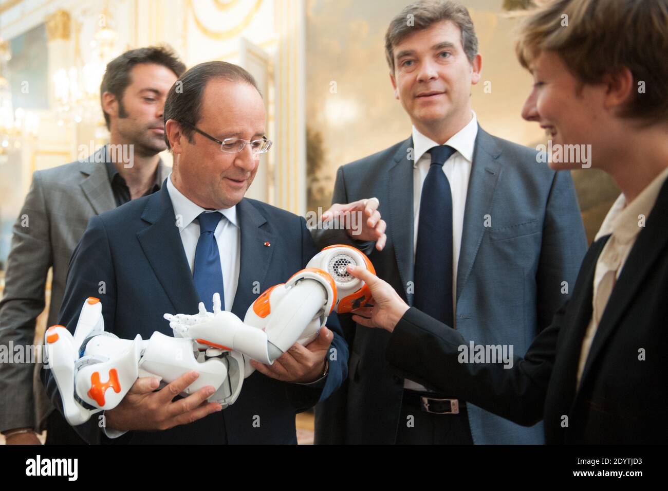 France's President Francois Hollande holds an humanoid robot 'Nao' from Aldebaran Robotics company as he visits an exhibition on French industrial design and technology at the Elysee Palace in Paris, France on September 12, 2013. At R, French Minister for Industrial Recovery Arnaud Montebourg. Photo by Thierry Orban/ABACAPRESS.COM Stock Photo