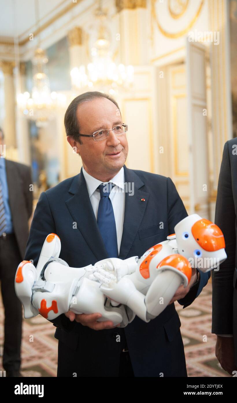 France's President Francois Hollande holds an humanoid robot 'Nao' from Aldebaran Robotics company as he visits an exhibition on French industrial design and technology at the Elysee Palace in Paris, France on September 12, 2013. Photo by Thierry Orban/ABACAPRESS.COM Stock Photo