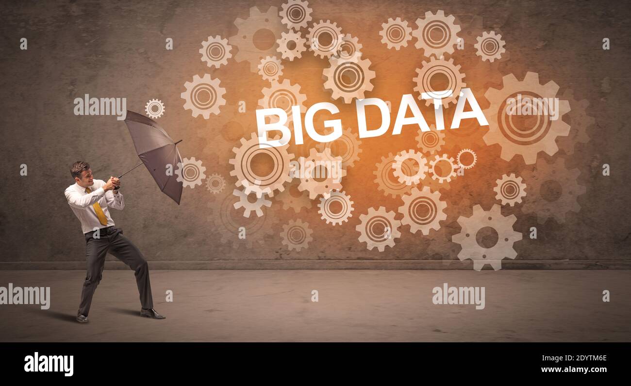 Businessman defending with umbrella from BIG DATA inscription ...