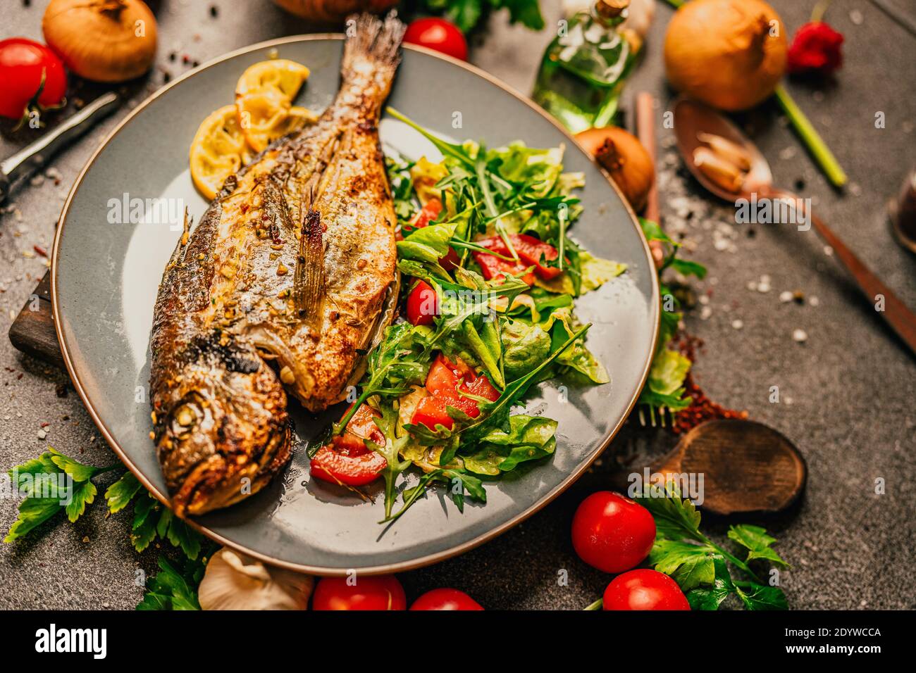 Prepared grilled gilthead sea bream.Fish diet meal.Seafood and vegetables for good health.Expensive dorado fish recipe.Healthy Mediterranean diet.Maki Stock Photo