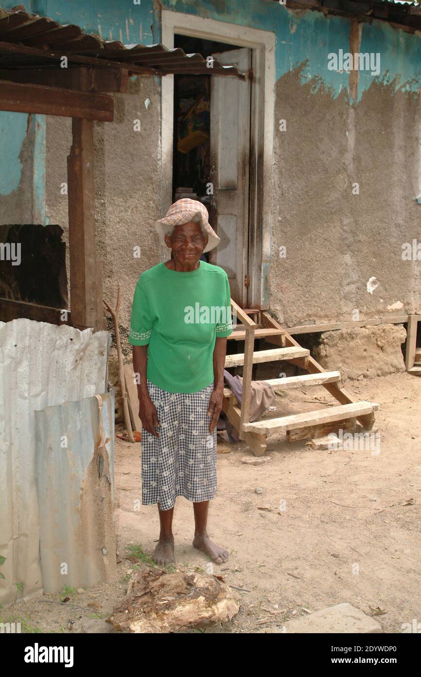 Ocho Rios, Jamaica. 81 year old woman standing in front of her house