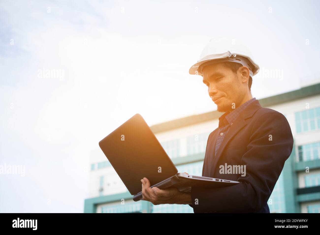 Engineer Notebook laptop work at  building sky background Stock Photo