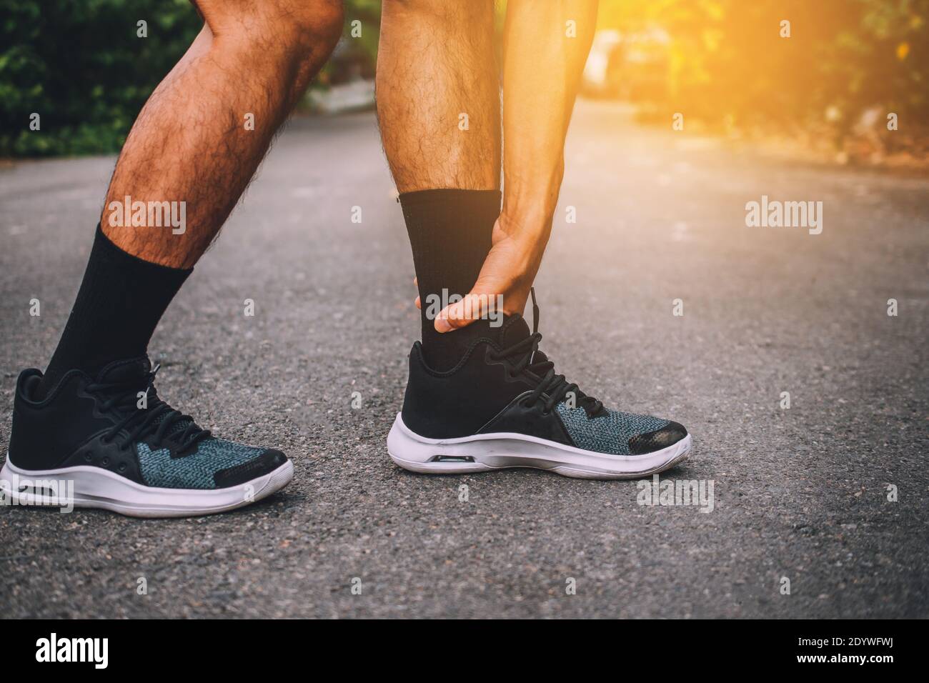 Runners injured on the ankle while running Stock Photo Alamy