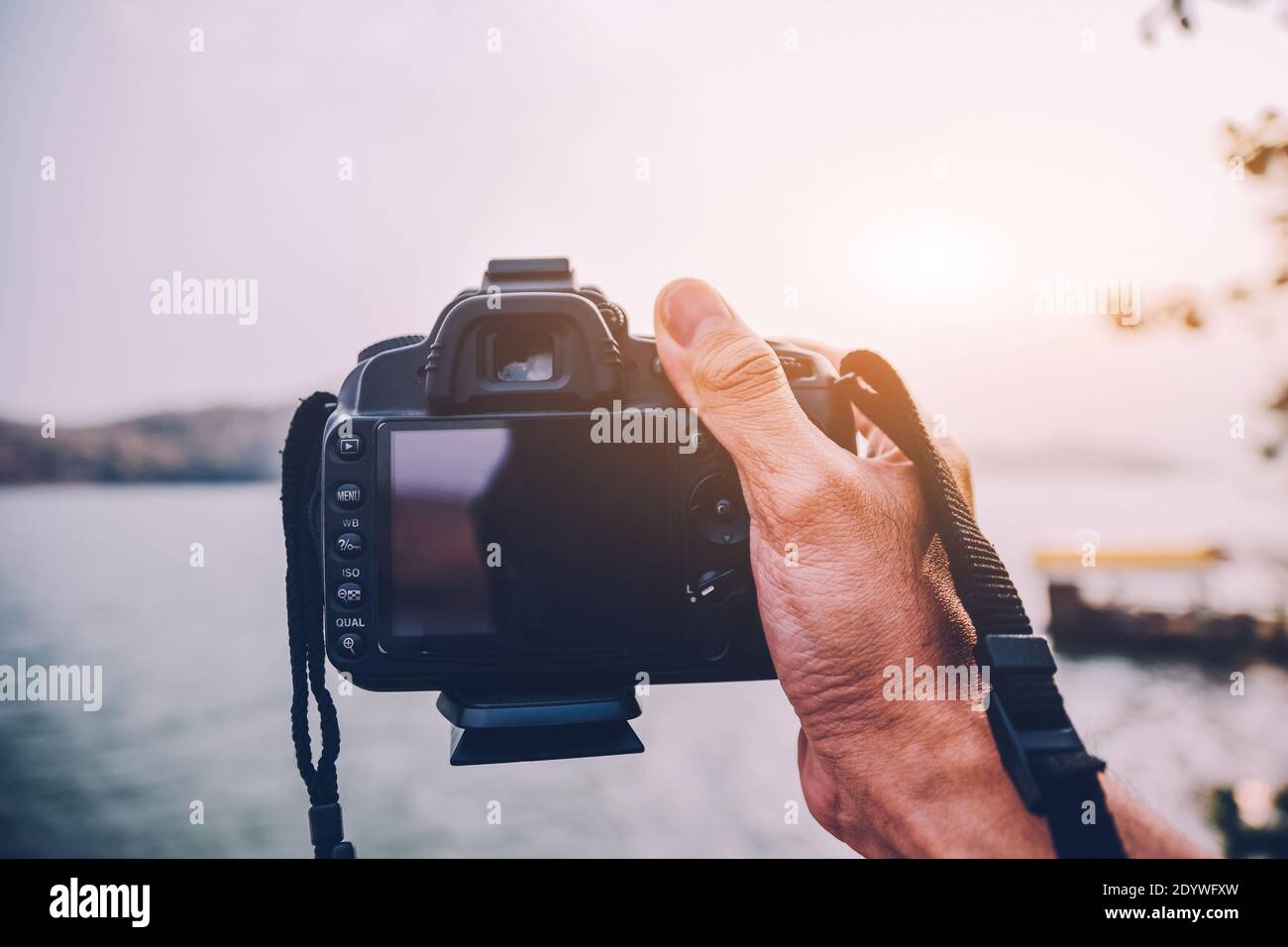 Hand holding Camera DSLR taking photo Stock Photo - Alamy