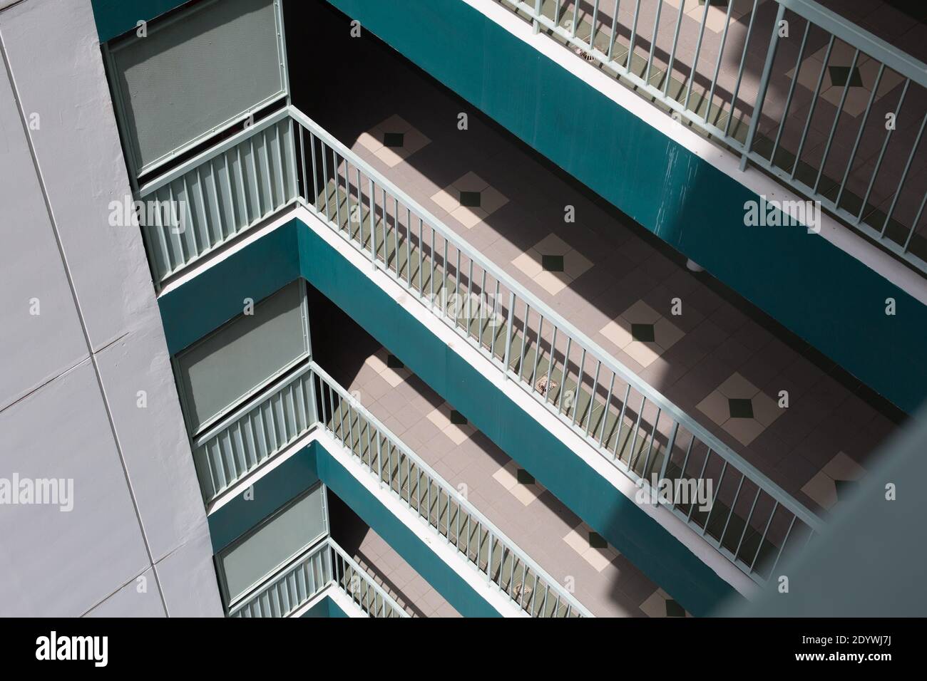 Wiew of a common corridor area with deck railing at a public housing ...
