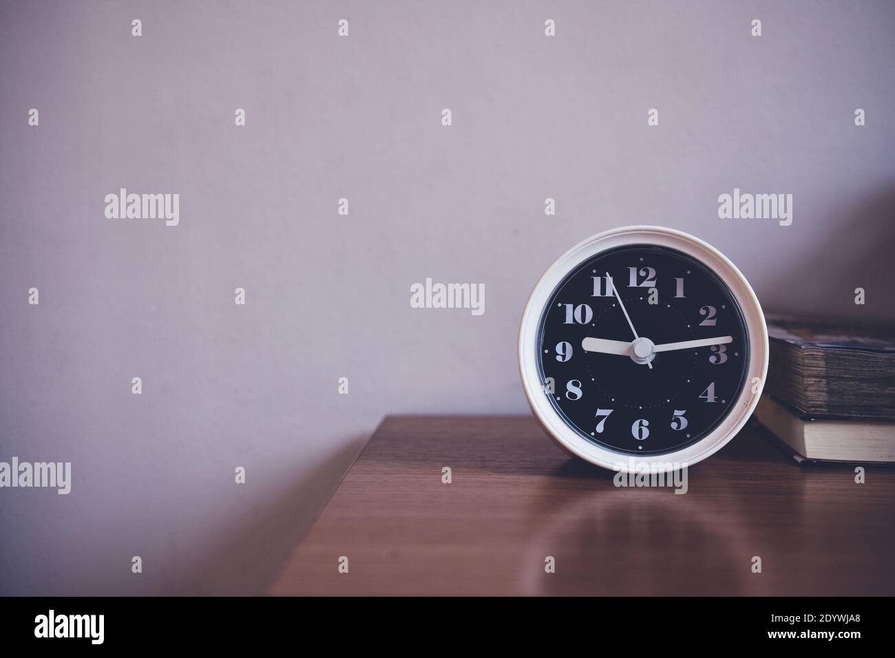 The clock is on table in bedroom Stock Photo Alamy