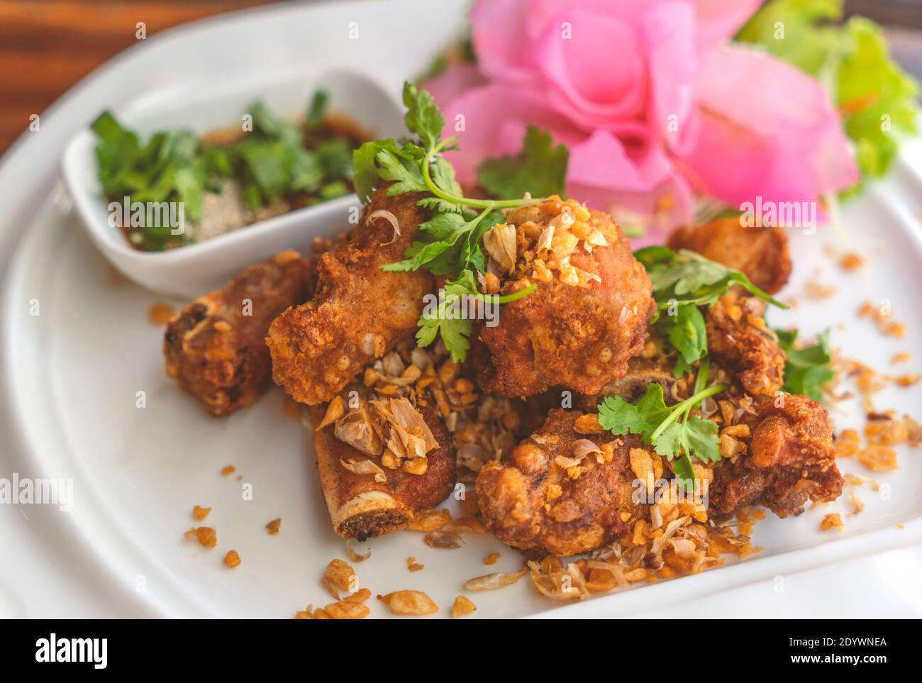 Deep fried spare ribs with garlic on white plate, beautiful food