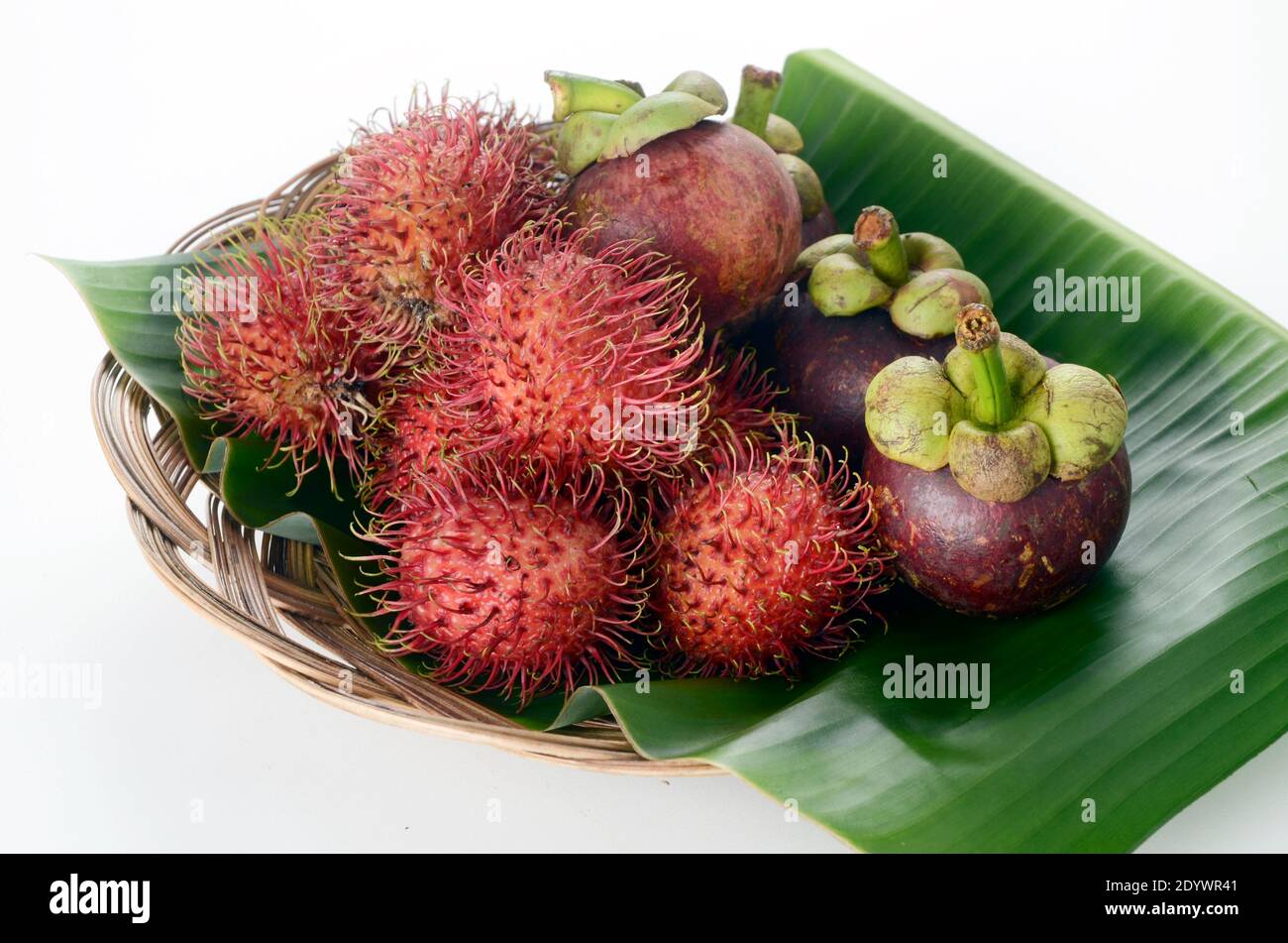 Mangosteen and Rambutan on Banana leaf plater, Nephelium lappaceum Stock Photo