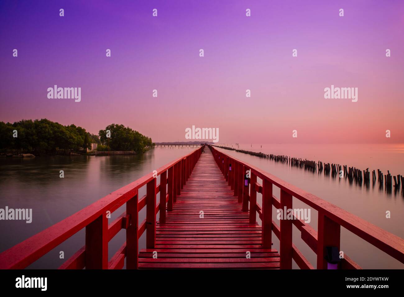 Long Red Bridge sunlight sky tree at beach sea,Red bridge Samut Sakhon