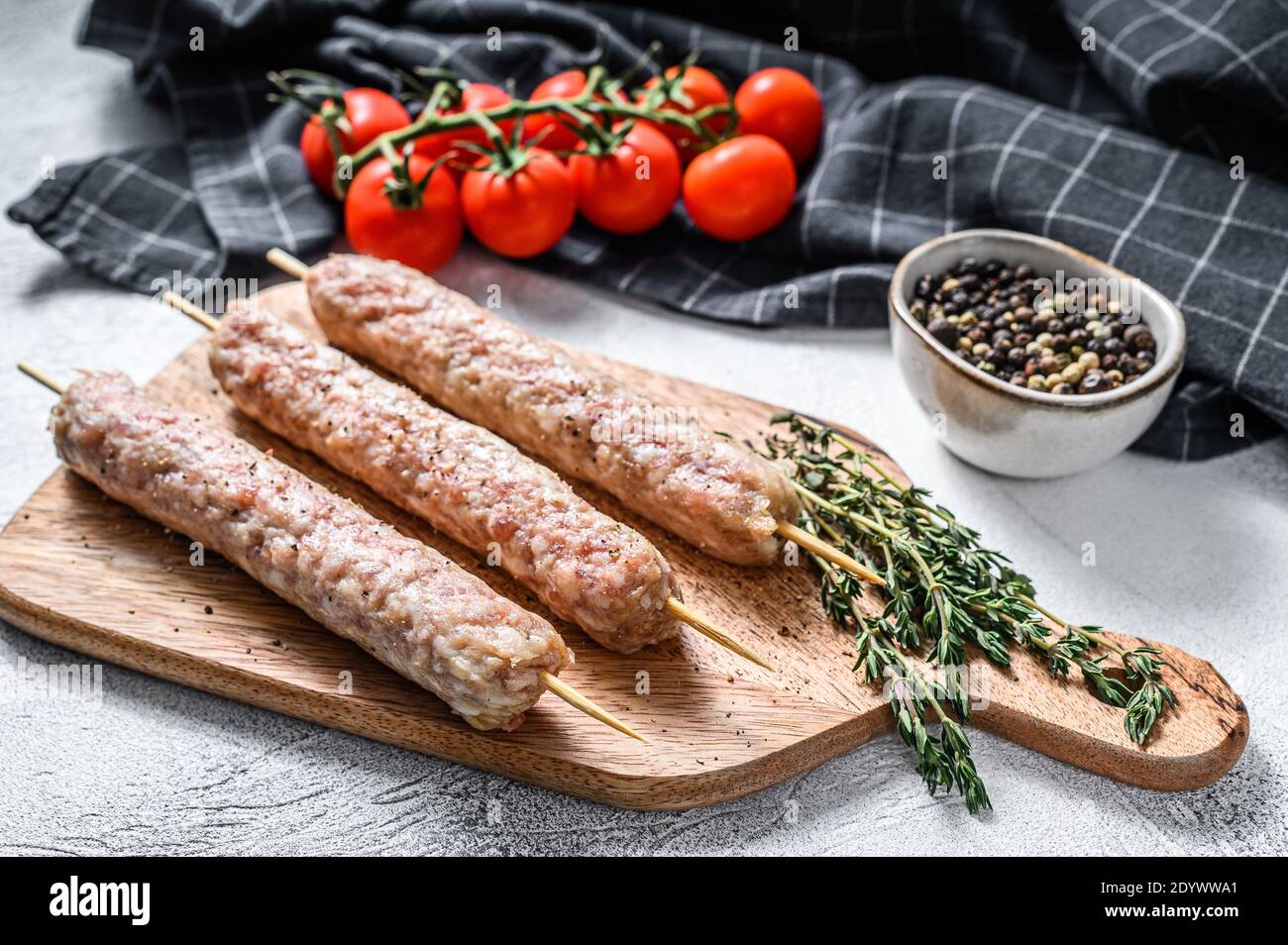 Fresh raw minced pork meat skewers kebabs. White background. Top view