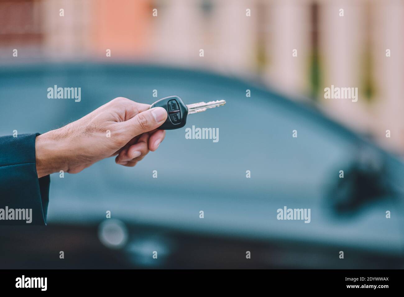 Business people holding key at car Stock Photo - Alamy