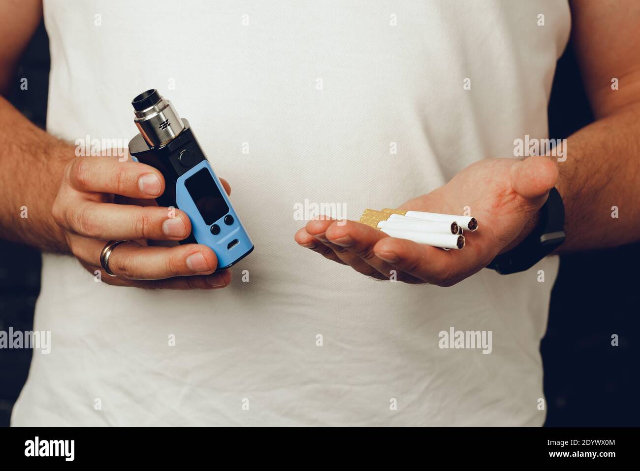 Male holding cigarettes and vape inhaler close up Stock Photo - Alamy