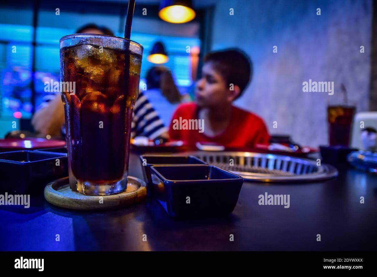 People are sitting in a restaurant and soft drinks are placed on the