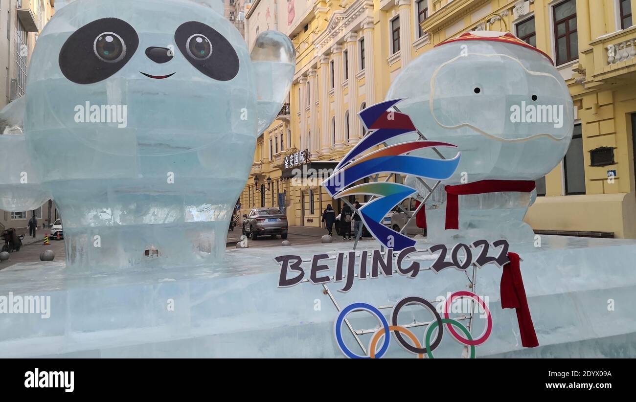 Two ice sculptures depicting the official mascots of 2022 Winter Olympics, Bing Dwen Dwen and Shuey Rhon Rhon, stand with the Olympic Rings around in Stock Photo
