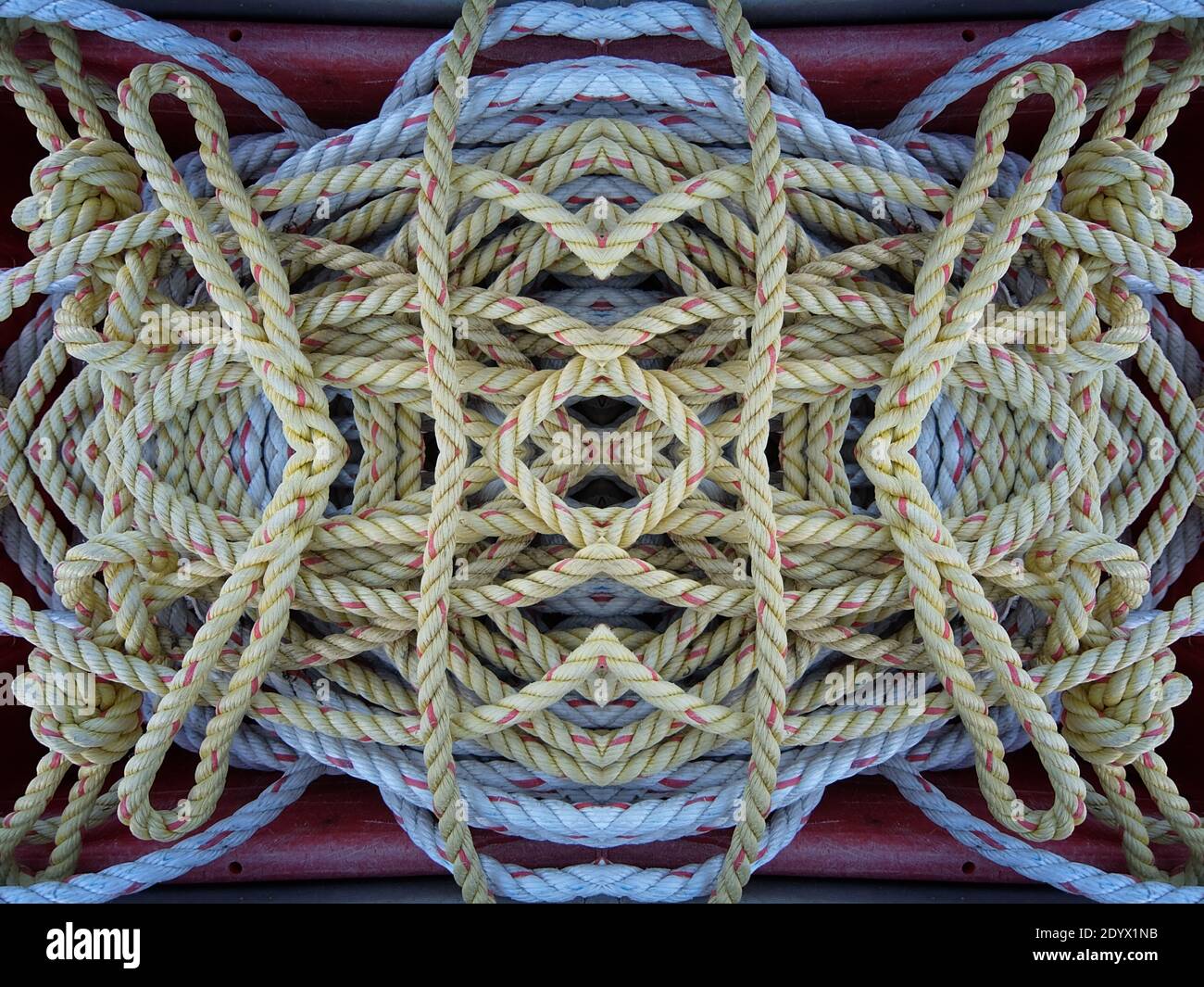 A kaleidoscope pattern of overlapping and knotted rope forming complex ...