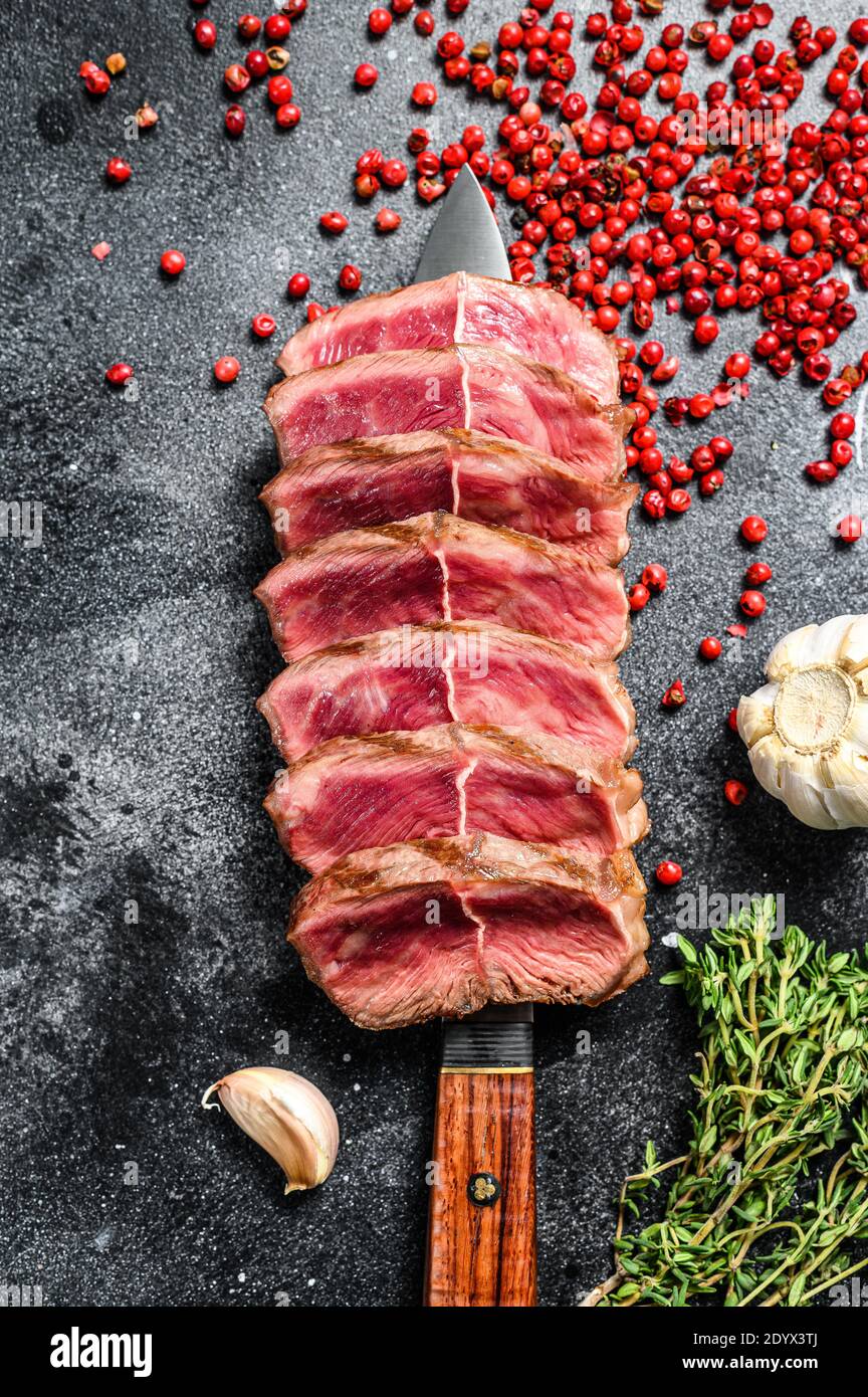 Sliced Grilled Top Blade steak. Organic beef meat. Black background ...