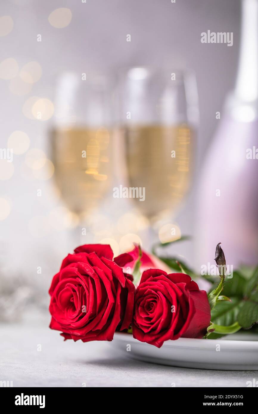 Valentines day table setting red roses and champagne glasses on ...