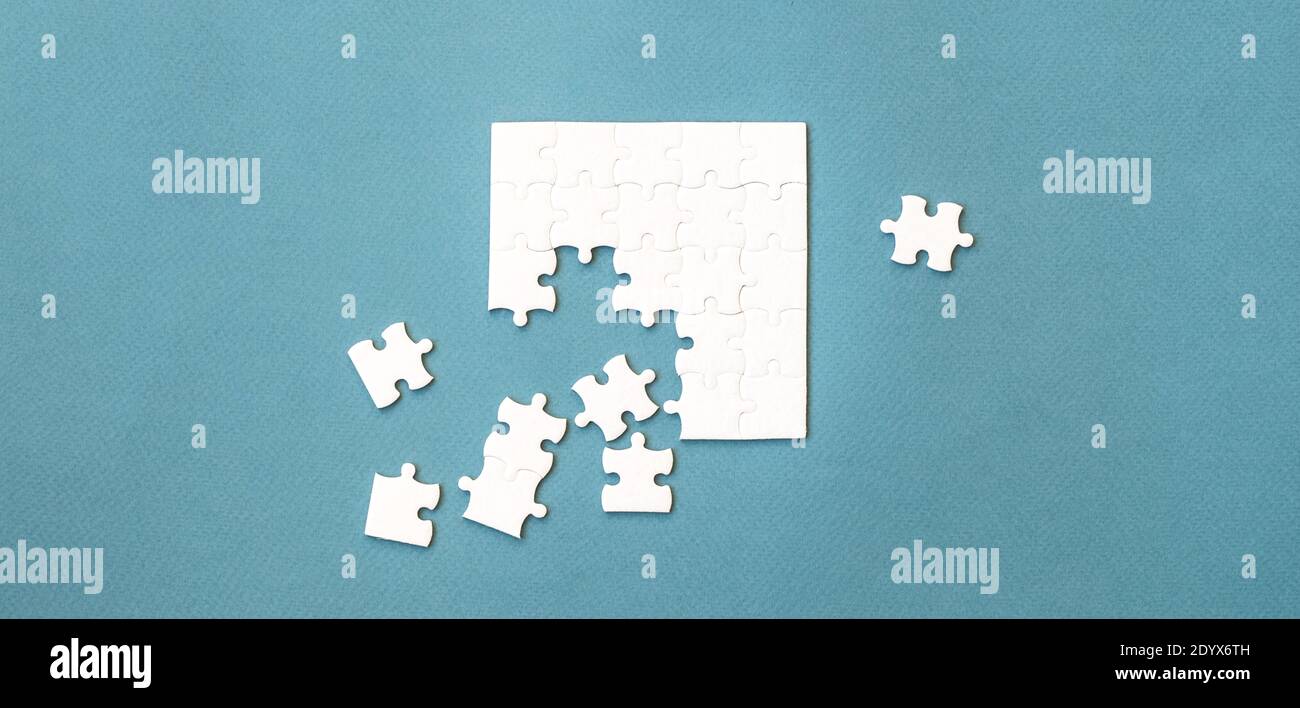 Small white square puzzle on a blue background Stock Photo