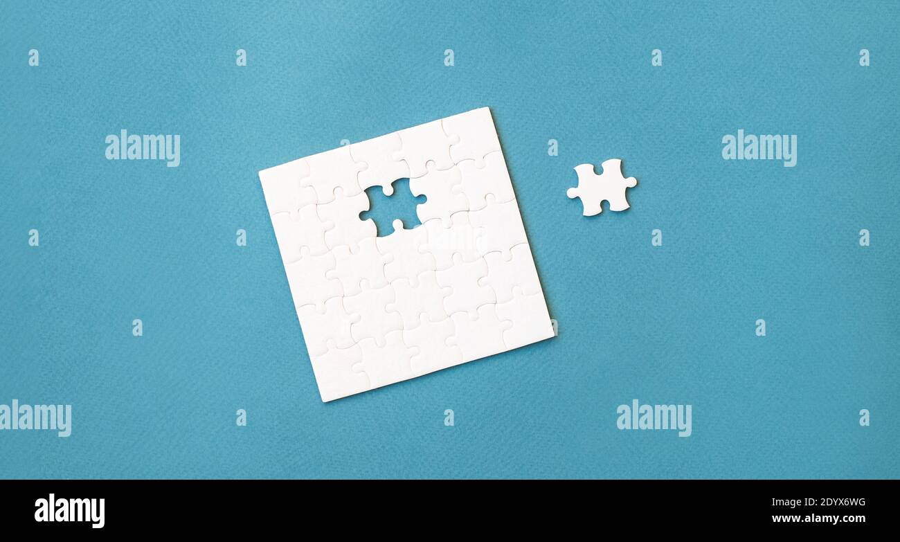 Small white square puzzle on a blue background Stock Photo