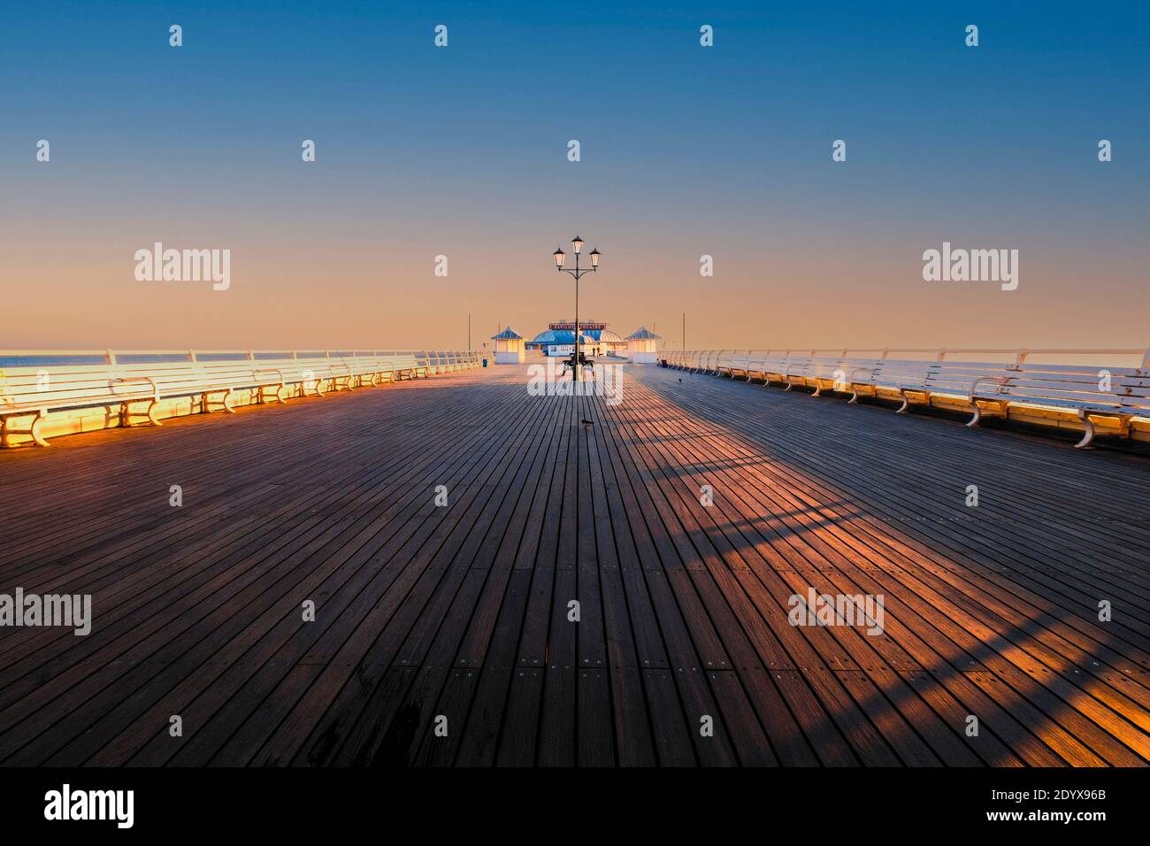 View along Cromer pier at sunrise. Stock Photo