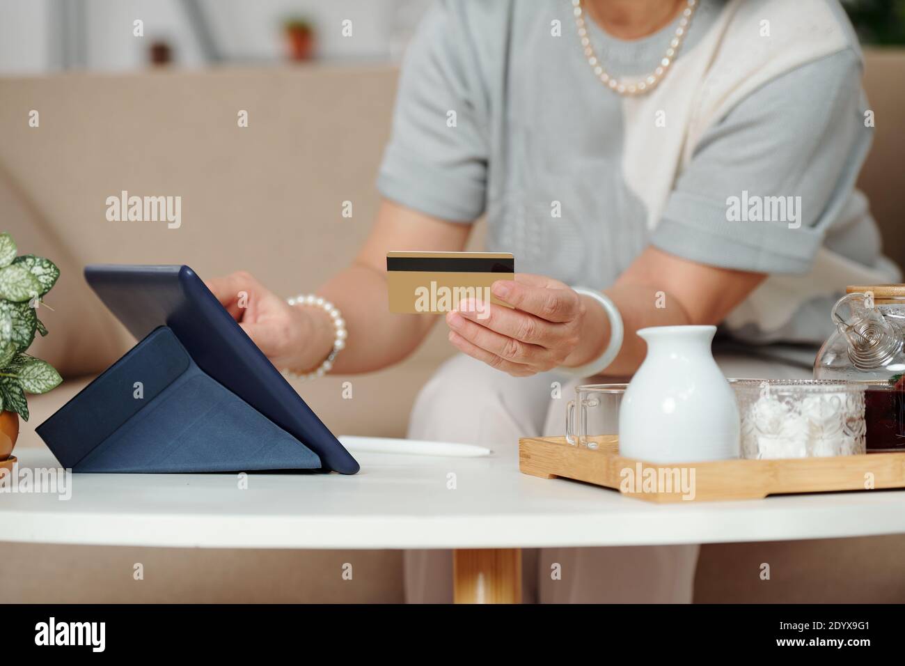 Aged woman shopping online Stock Photo