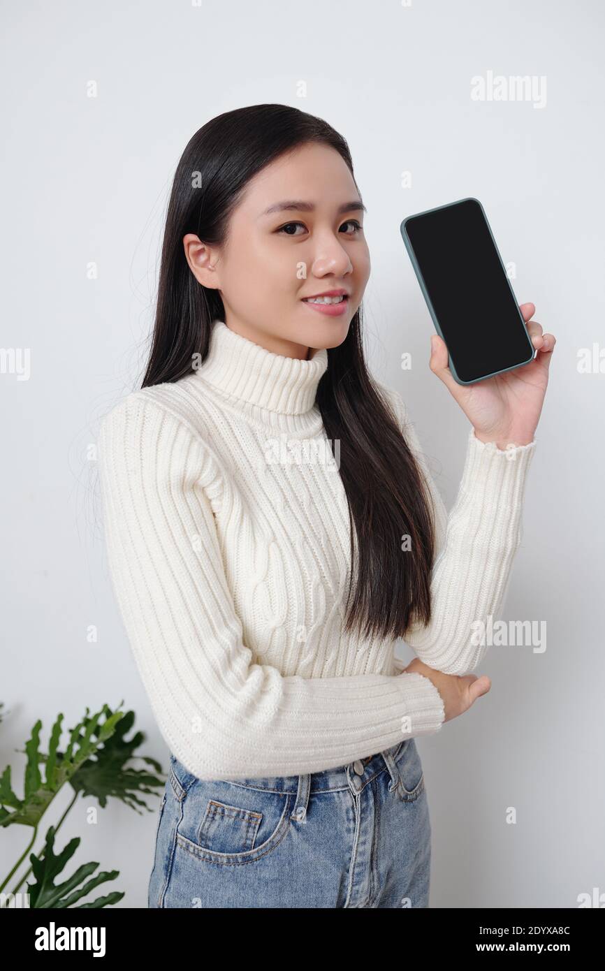 Young woman showing smartphone Stock Photo