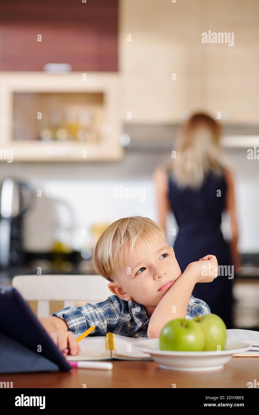 Pensive boy doing homework Stock Photo