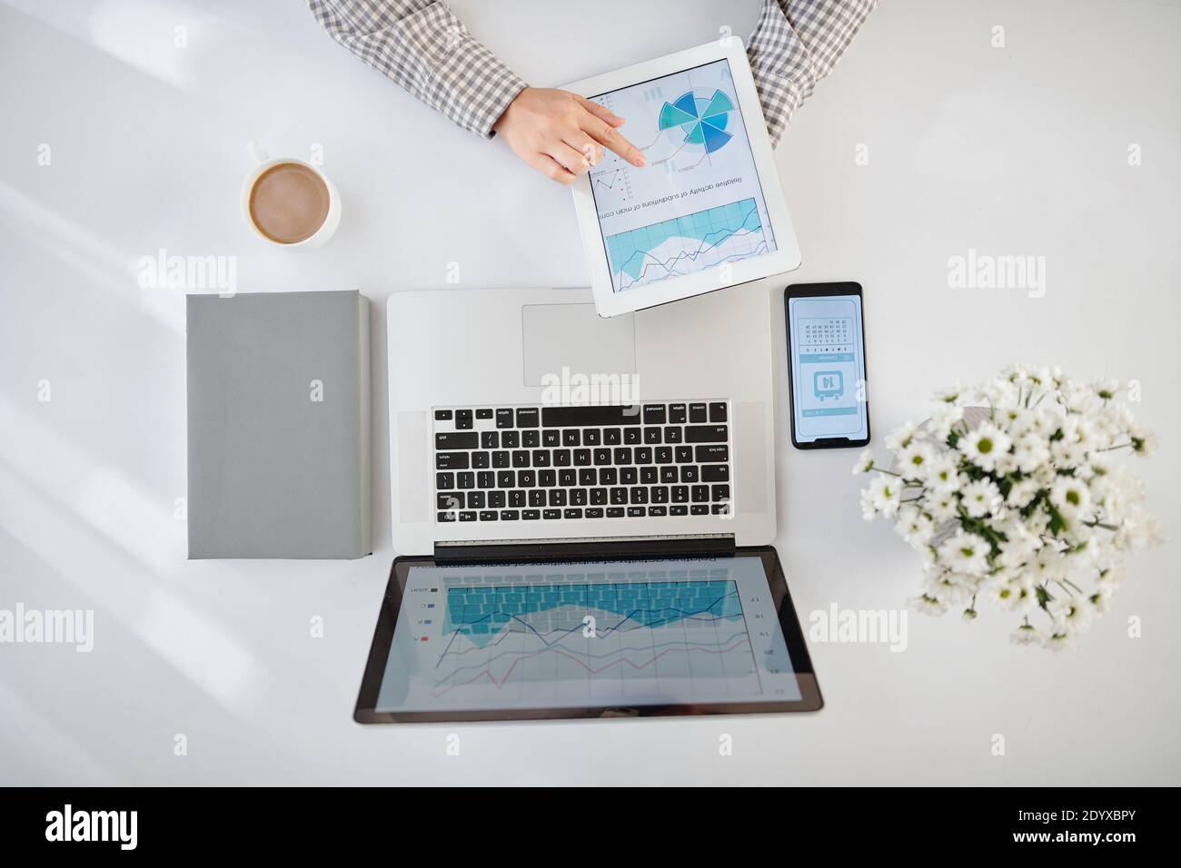 Businesswoman analyzing statistics Stock Photo