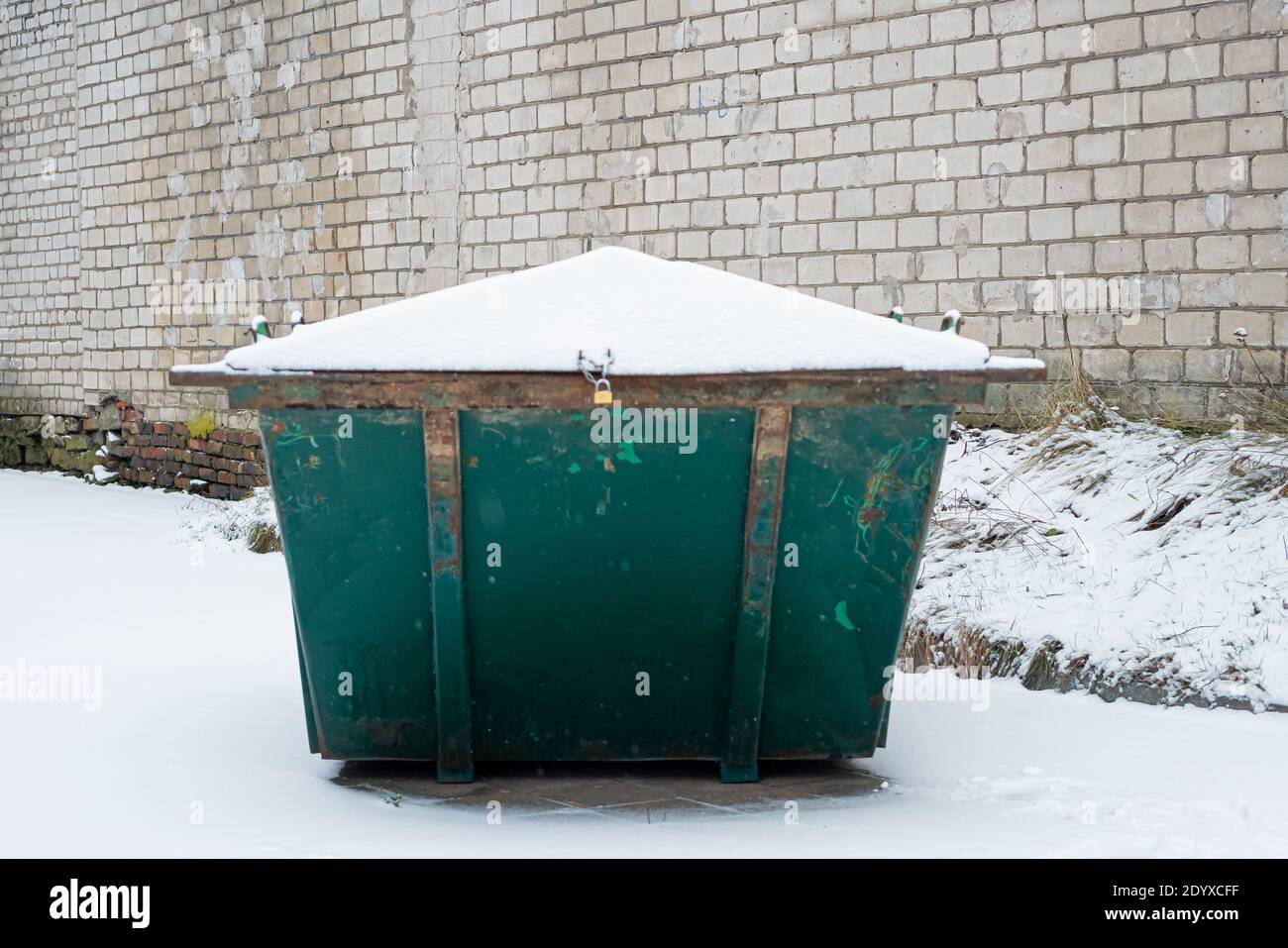 Waste management green trash can used in community where people throw
