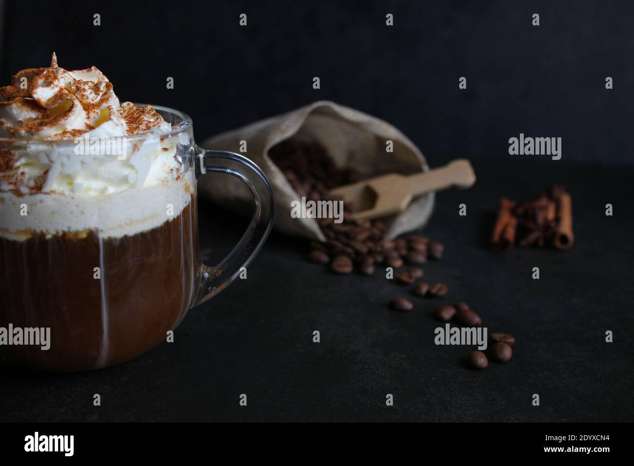 Cappuccino with cinnamon. A glass of fresh cappuccino on the table Stock Photo