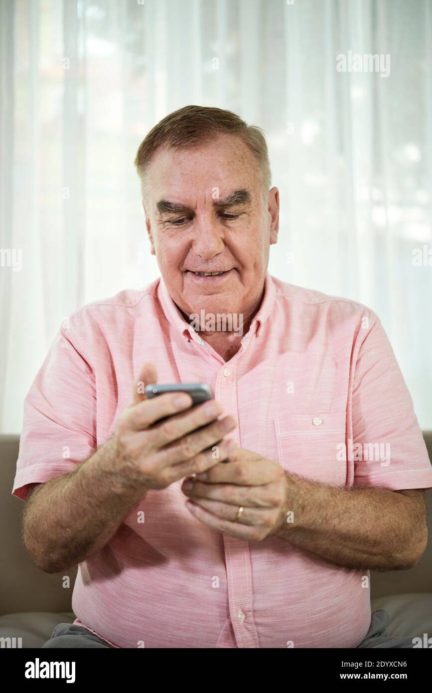 Seniors men text messaging hi-res stock photography and images - Alamy