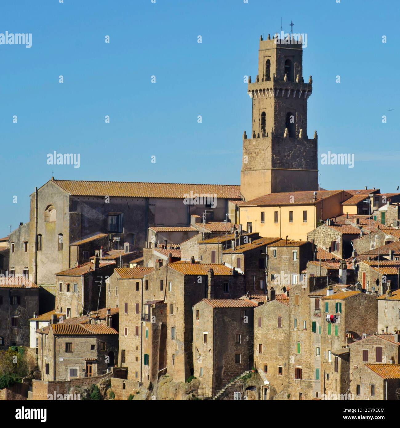 A stretch of the medieval Pitigliano town in the Tuscan country against the blue sky Stock Photo