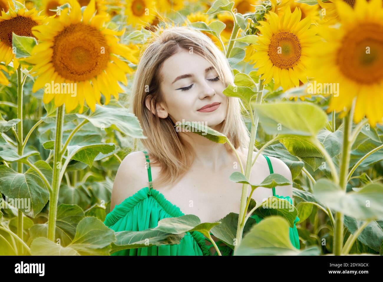 beautiful young girl in sunflowers happy smiling Stock Photo - Alamy