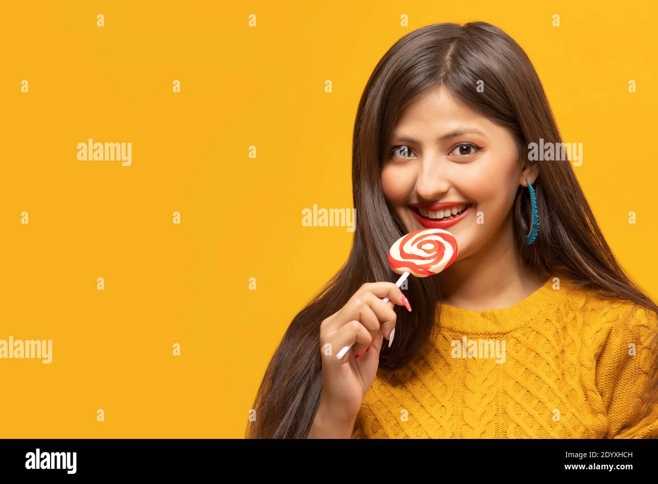 Portrait of a young woman holding a lollipop in hand Stock Photo
