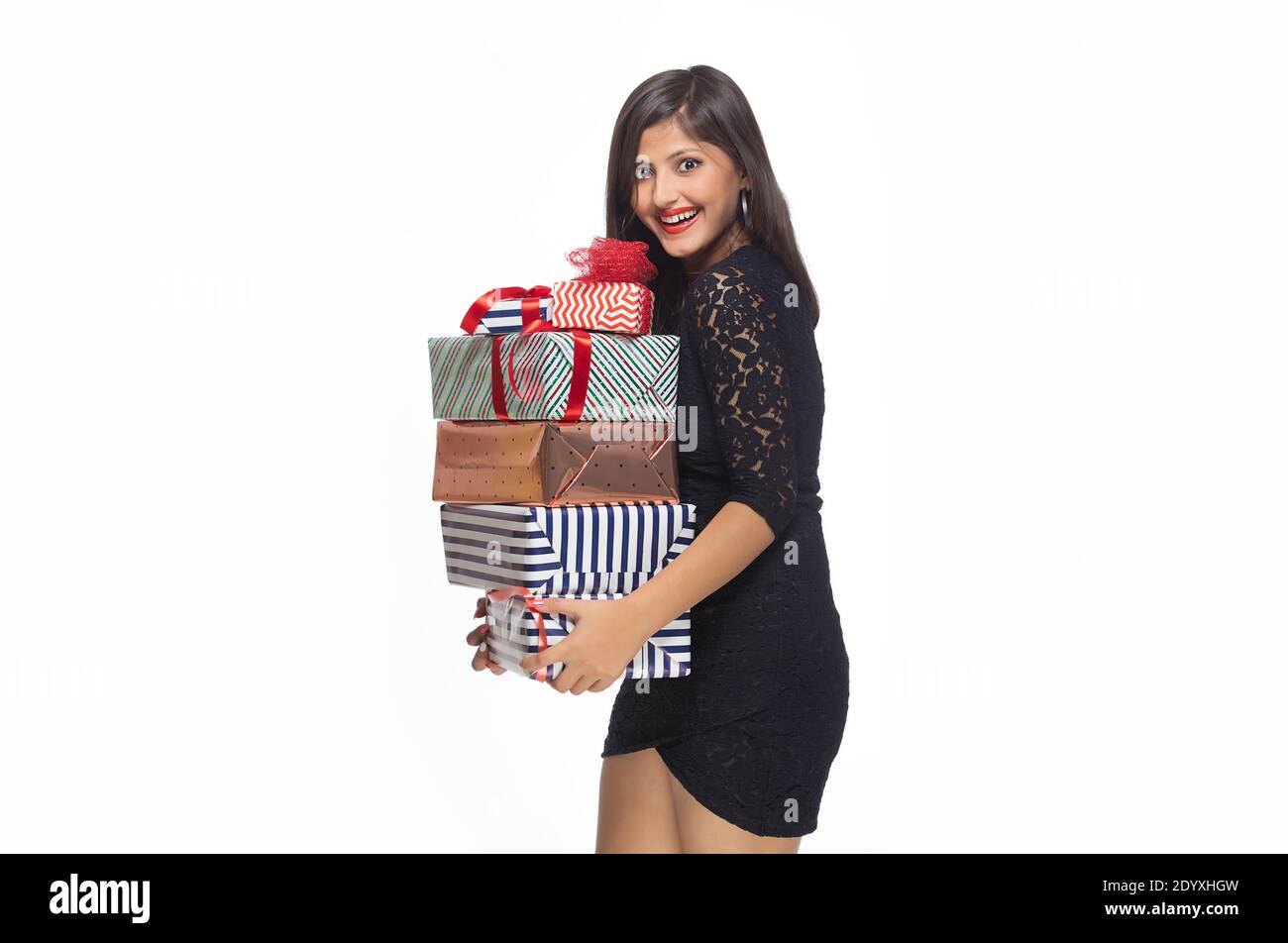 Happy young woman holding gift boxes Stock Photo