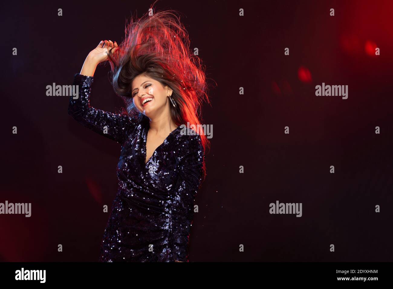 Happy Young woman Dancing celebrating the New Year party Stock Photo