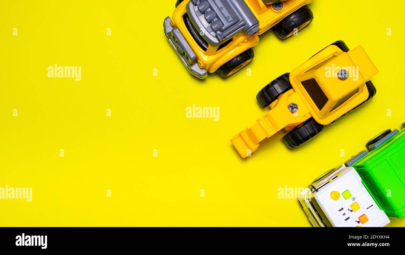 Lots of toy cars on a yellow background banner with a place for text for a toy store Stock Photo