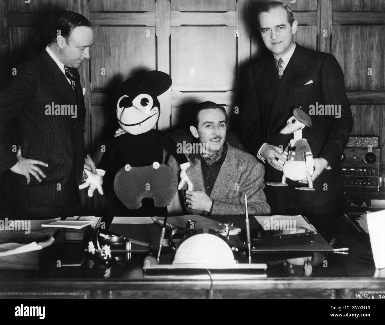 MERLIN H. AYLESWORTH Chairman of the Board of Radio Pictures MICKEY WALT DISNEY with MICKEY MOUSE soft toy and NED DEPINET President of RKO Radio with DONALD DUCK toy at signing of Contract in 1936 making RKO Radio Pictures sole distributer of Disney Cartoons and Silly Symphonies beginning 1936 - 37 publicity for Walt Disney Productions / RKO Radio Pictures Stock Photo