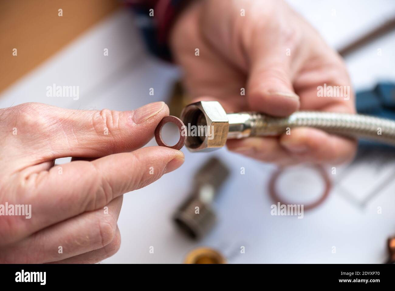 Plumber putting a gasket on a plumbing fitting Stock Photo Alamy