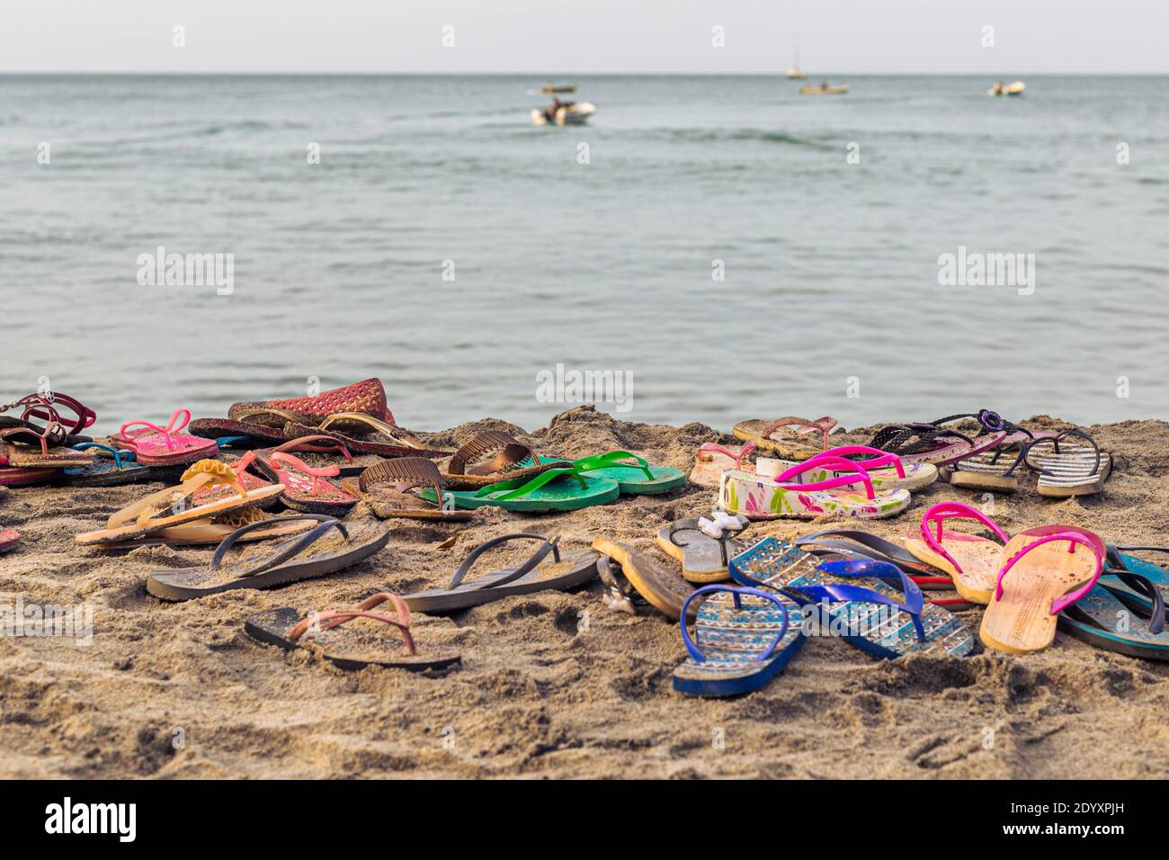 Flip-flops left in the sand at a beach in Sri Lanka Stock Photo