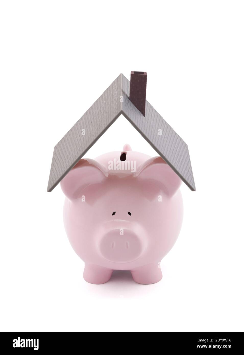 Pink piggy bank with house roof on white background Stock Photo