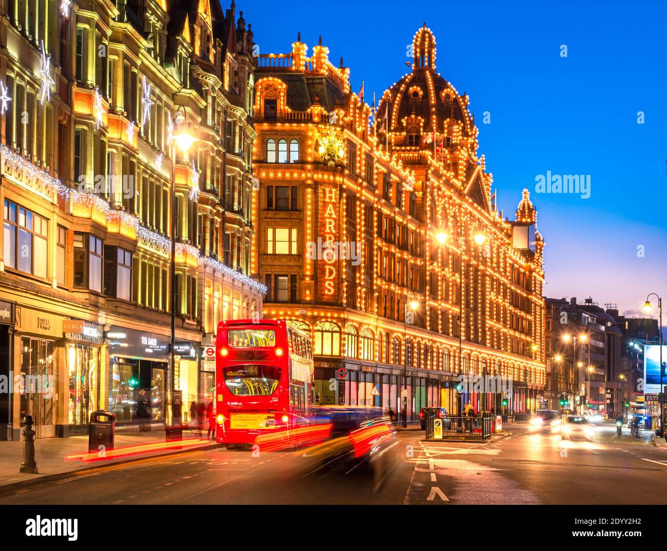 London, England, UK - December 27, 2020: Harrods luxury building in London illuminated at dusk to down Stock Photo