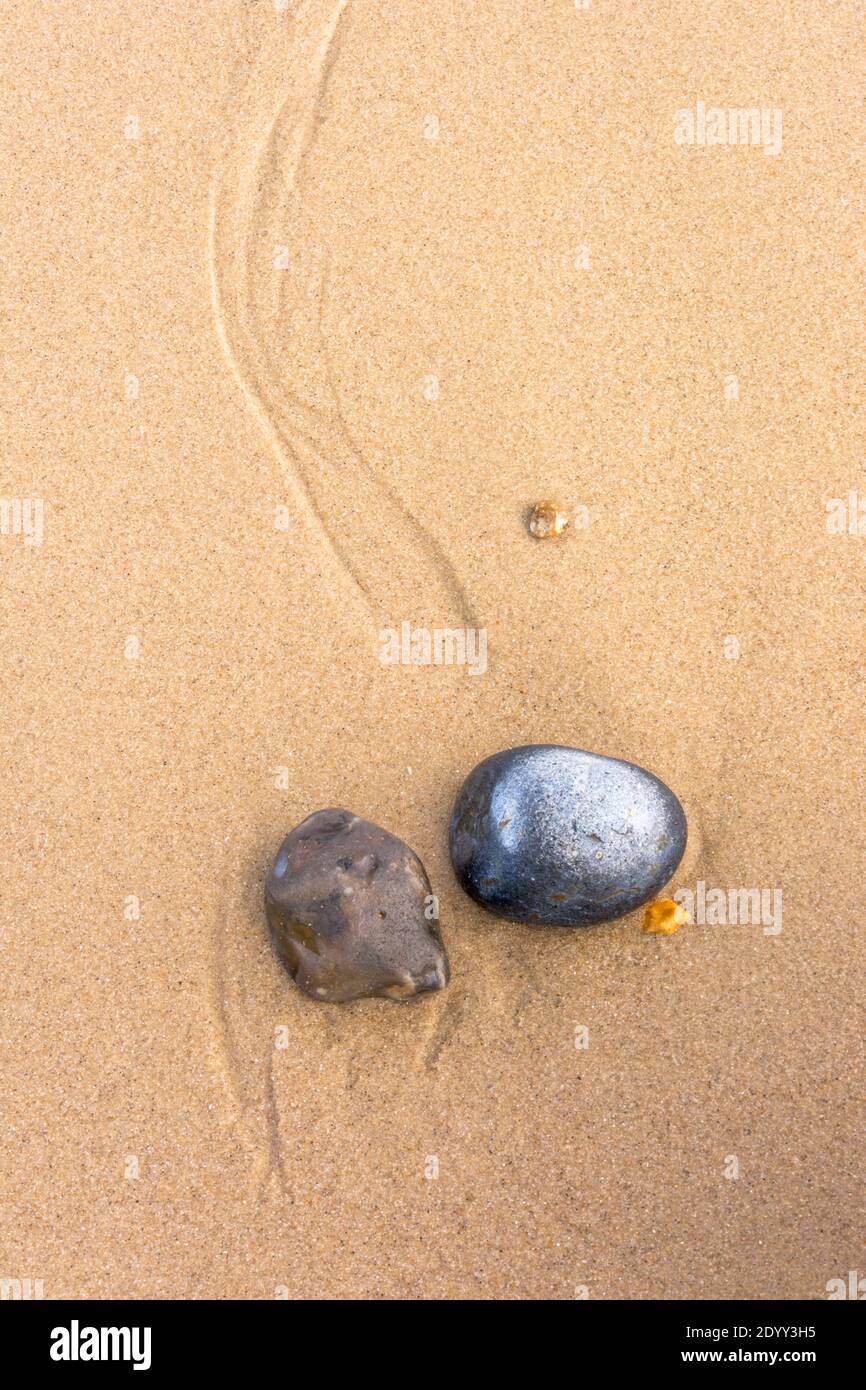 Pebbles on the sand, Norfolk, England Stock Photo